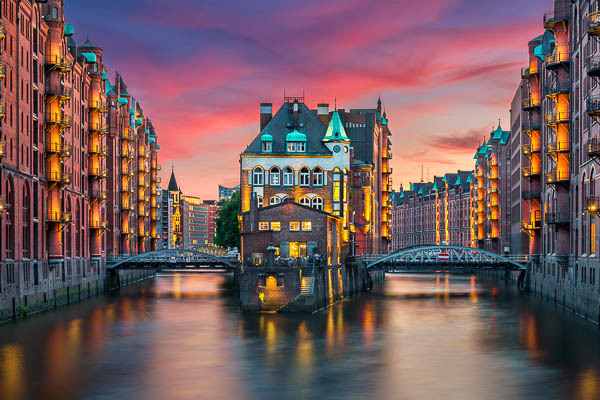 Sunset at the famous Wasserschloss building in the historic Speicherstadt in Hamburg, Germany by Michael Abid