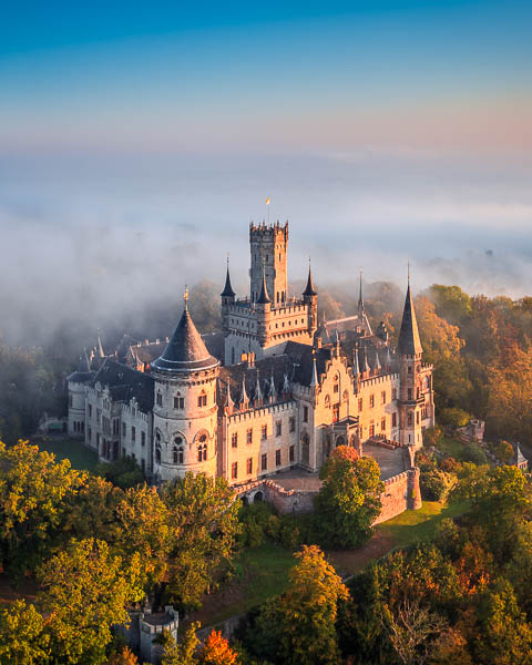 Marienburg Castle near Hannover, Germany on a foggy autumn morning by Michael Abid