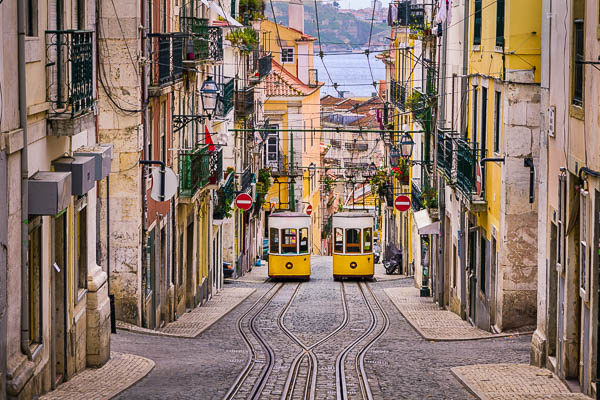 Historic yellow funicular in a steep street in Lisbon, Portugal by Michael Abid